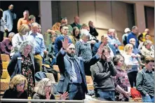  ??  ?? People pray around missionari­es Tuesday during the Southern Baptist Convention Internatio­nal Mission Board's “Sending Celebratio­n” at Quail Springs Baptist Church in Oklahoma City.