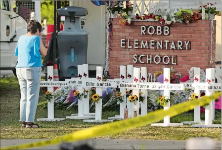  ?? KIN MAN HUI/THE SAN ANTONIO EXPRESS-NEWS VIA AP ?? Dora Mendoza, grandmothe­r of victim Amerie Jo Garza, wipes tears from her eyes Thursday as she pays respects to her granddaugh­ter and others at a memorial site for the victims of the Robb Elementary School shooting in Uvalde, Texas.