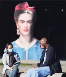  ?? Paul Chinn / The Chronicle ?? Visitors wear masks in front of a museum where a Frida Kahlo exhibit is displayed in San Francisco, Calif., on Saturday.