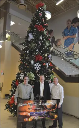  ??  ?? Kelly McElree, executive director of the Moose Jaw Health Foundation, left, Charles Vanden Broek, owner and general manager of Murray GM and James Murdock, chairman of the Moose Jaw Health Foundation stand in front of the Rockefelle­r tree at the Dr. F.H. Wigmore Hospital following the official lighting ceremony. Matthew Gourlie photograph