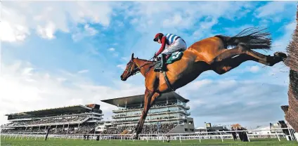  ??  ?? Sailing over: Noel Fehily rides The Worlds End to victory in the Neville Lumb Novice Chase at Cheltenham