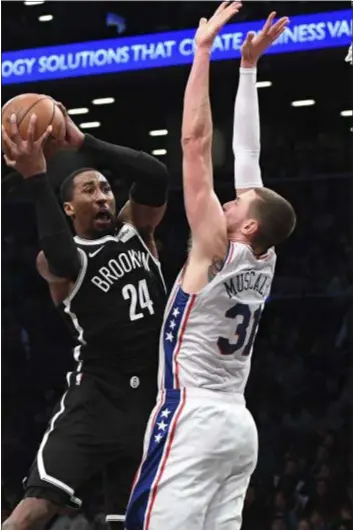  ?? KATHLEEN MALONE-VAN DYKE — THE ASSOCIATED PRESS ?? Nets forward Rondae Hollis-Jefferson shoots over the Sixers’ Mike Muscala Sunday. The Chester native scored 21 points in a 122-97 beatdown by Brooklyn.