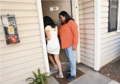  ?? Photos by Scott Strazzante / The Chronicle ?? Aleida Ramirez and her daughter, Emily, 11, enter their home at Clayton Crossing Apartments in Concord.