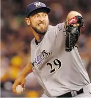  ?? Afp/getty Images/files ?? Calgary’s Jim Henderson, who pitches for the Milwaukee Brewers, has improved his ERA to 2.41 this season.