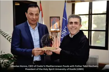  ?? ?? Charles Hanna, CEO of Cedar’s Mediterran­ean Foods with Father Talal Hachem, President of the Holy Spirit University of Kaslik (USEK)