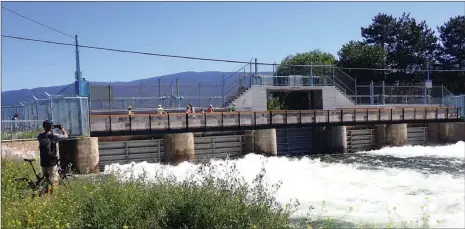  ?? J.P. SQUIRE/Special to Okanagan Newspaper Group ?? Water from Okanagan Lake is cascading past the flow control structure or dam at the north end of the Penticton River Channel, above. That means a fast float down the popular channel to its mouth at Skaha Lake. If you are not floating, the dam walkway is a pleasant place to cool off from the summer heatwave and enjoy the summer flowers.