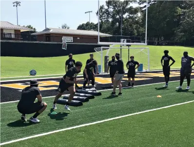  ?? Staff photo by Josh Richert ?? ■ Pleasant Grove linemen run through drills during the first day of fall football camp Monday at Hawk Stadium.