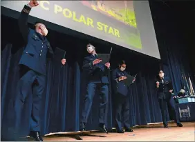  ?? DANA JENSEN THE DAY ?? First-class Cadets Mikael Axelson, Aidan Uvanni, Salena Bantz and Drusilla Corbett react Thursday after discoverin­g they will be going to the icebreaker USCG cutter Polar Star during billet night at Leamy Hall on the Coast Guard Academy campus in New London.