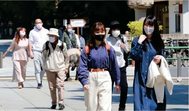  ?? Associated Press ?? ↑
People, wearing face masks, visit the Yasukuni Shrine in Tokyo on Wednesday.