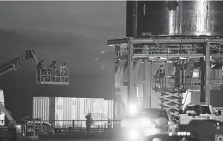  ?? Kin Man Hui / Staff photograph­er ?? SpaceX personnel work on the company’s Starship SN10 at a launch facility near Boca Chica Village last month. NASA chose SpaceX to lower the agency’s next two astronauts to the moon.