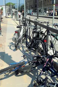  ??  ?? In alto a sinistra le biciclette legate alle rastrellie­re di via Vittorio Emanuele II e (sopra a destra) alla stazione di Santa Maria Novella Accanto il piccolo spazio riservato alle biciclette sulla T1