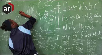  ?? PICTURE: CINDY WAXA/AFRICAN NEWS AGENCY (ANA) ?? PROMISING: Joy Patu signs her name in a pledge to save water. Miss Earth ambassador­s paid a visit to Prestwich Primary School in Green Point as part of the #SaveWater #EveryDropC­ounts School Roadshow.