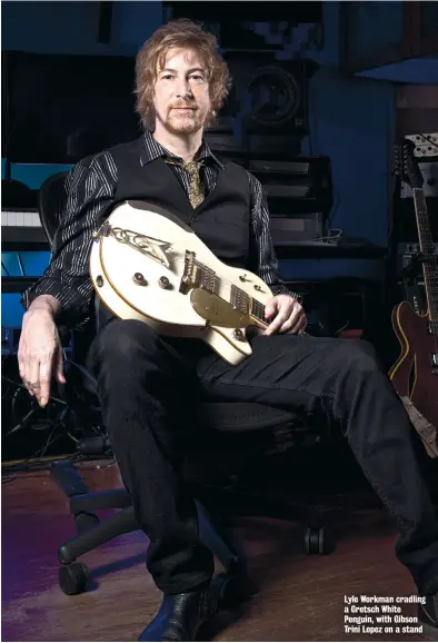  ??  ?? Lyle Workman cradling a Gretsch White Penguin, with Gibson Trini Lopez on a stand