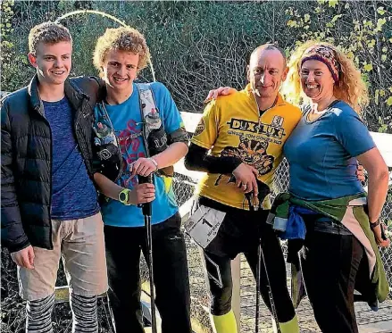  ??  ?? Yonni Kepes at the end of his 100 mile ultra marathon with brother Omri, dad Ben and mum Viv.