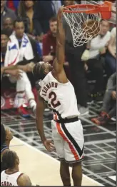  ?? KEVIN REECE Special to the Valley Press ?? SEASON HIGH
Los Angeles Clippers forward Kawhi Leonard, left, dunks as Cleveland Cavaliers center Tristan Thompson, bottom left in black, looks on during the second half on Tuesday in Los Angeles. Leonard scored a season-high 43 points and the Clippers won 128-103.