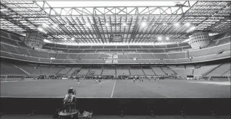  ?? AP ?? AC Milan and Genoa play at an empty San Siro stadium in Milan on March 8 before Serie A was suspended.