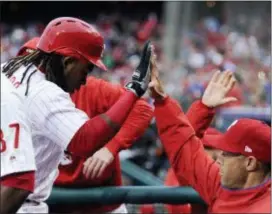  ?? MICHAEL PEREZ — THE ASSOCIATED PRESS ?? Phillies third baseman Maikel Franco, left, celebrates with manager Gabe Kapler after Franco hit a grand slam in the first inning Saturday at Citizens Bank Park.