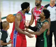  ?? ASHLEY LANDIS – THE ASSOCIATED PRESS ?? Philadelph­ia 76ers’ Joel Embiid, left, and Boston Celtics’ Marcus Smart, right, exchange words during the second half of an NBA basketball first round playoff game Monday night.