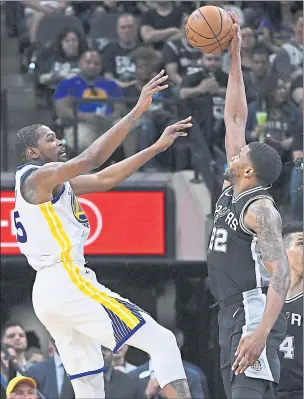  ?? JOSE CARLOS FAJARDO — STAFF PHOTOGRAPH­ER ?? The Spurs’ Rudy Gay epitomized his team’s tenacious effort, blocking a shot by the Warriors’ Kevin Durant, as San Antonio stayed alive in the first-round series with a 103-90 victory Sunday.