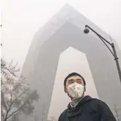  ?? KEVIN FRAYER, GETTY IMAGES ?? A man wears a protective face mask on a day of heavy pollution Monday in Beijing.