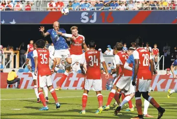  ?? KARLMONDON/STAFF PHOTOS ?? Jelle Van Damme, left, of the MLS All-Stars, takes a headshot in first-half play against the English club Arsenal at Avaya Stadium. At right, Didier Drogba, listens to the cheers after scoring a tying goal during the opening half Thursday.“Every time,...