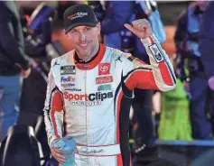  ?? GARY A. VASQUEZ/ USA TODAY SPORTS ?? Denny Hamlin celebrates his victory Saturday night in the Clash at the Coliseum.