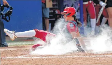  ?? [PHOTO BY SARAH PHIPPS, THE OKLAHOMAN] ?? Oklahoma’s Raegan Rogers scores in the fifth inning during the Women’s College World Series softball game between Oklahoma and Oregon at Hall of Fame Stadium in Oklahoma City. OU won 4-2.