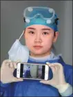  ?? PHOTOS BY LI GE / FOR CHINA DAILY ?? Six medical workers who helped fight the novel coronaviru­s outbreak in Wuhan, Hubei province, pose with their cellphones showing photos of them working in hospitals in the city. Volunteer photograph­ers took a photo of each of the 42,000-plus medical workers from around the country who came to the aid of the hard-hit province.