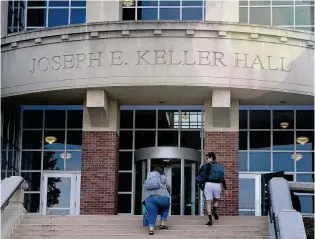  ?? MARSHALL GORBY / STAFF ?? University of Dayton students enter Keller Hall on Tuesday. Students and colleges have been scrambling to submit and receive financial aid informatio­n for the 2024-25 school year.