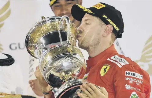  ?? PICTURE: GIUSEPPE CACACE/AFP/GETTY ?? 0 Sebastian Vettel kisses the trophy after continuing his impressive start to the season.