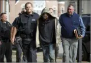  ?? SHOLTEN SINGER — THE HERALD-DISPATCH VIA AP ?? Lawrence County Sheriff Jeff Lawless escorts in Arron Lee Lawson after he was captured on Friday in Ironton, Ohio. Lawson has been arrested on three counts of murder and one count of aggravated murder.