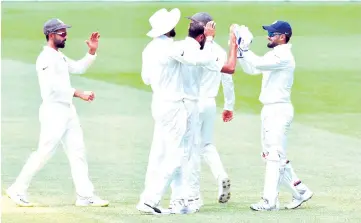  ??  ?? India’s wicketkeep­er Rishabh Pant (R) celebrates with teammates the dismissal of Australia’s batsman Mitchell Starc during day five of the first Test cricket match between Australia and India at the Adelaide Oval on December 10, 2018. - AFP photo