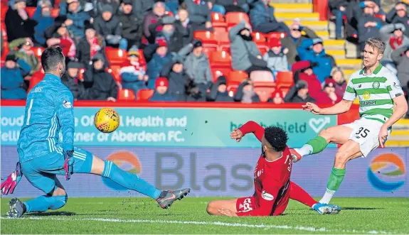  ?? Picture: SNS Group. ?? Kristoffer Ajer beats Aberdeen keeper Joe Lewis to net Celtic’s winner.