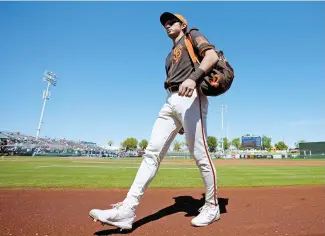  ?? AP-Yonhap ?? ◄ San Francisco Giants’ Lee Jung-hoo walks to the dugout prior to a spring training baseball game against the Chicago Cubs in Scottsdale, Ariz., March 22.