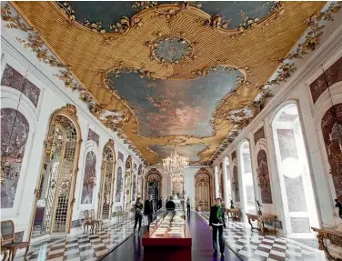  ?? Photo: REUTERS ?? People walk through the Mirror Hall of the Potsdam’s New Palace.