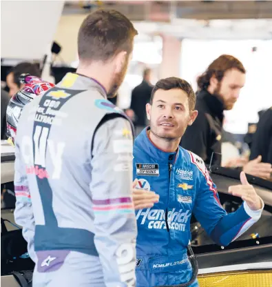  ?? GRANT HALVERSON/GETTY ?? NASCAR Cup champion Kyle Larson, right, talks with teammate Alex Bowman during Next Gen car testing on Nov. 17.