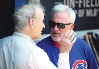  ??  ?? Bill Murray talks with Cubs manager Joe Maddon on June 11 before a game against the Braves. | SCOTT CUNNINGHAM/ GETTY IMAGES