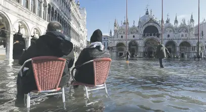  ?? Picture: Reuters ?? WET VIEW. People at the flooded St. Mark’s Square during a period of seasonal high water in Venice, Italy, yesterday.