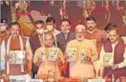  ?? PTI PHOTO ?? Chief minister Yogi Adityanath releases a book on completing 4.5 years of his government at Lok Bhawan in Lucknow, on Sunday. Deputy CMs Dinesh Sharma, KP Maurya and BJP state president Swatantra Dev are also seen.