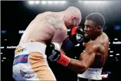  ?? ASSOCIATED PRESS ?? DANIEL JACOBS (RIGHT) punches Poland’s Maciej Sulecki during the third round of a middleweig­ht boxing match Saturday in New York.
