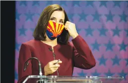  ?? Getty Images/tns ?? U.S. Sen. Martha Mcsally, R- Ariz. removes her mask as she prepares to debate Democratic challenger Mark Kelly at the Walter Cronkite School of Journalism at Arizona State University on Oct. 6 in Phoenix.