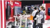  ?? PROVIDED TO CHINA DAILY ?? Visitors check out products at Rockwell Automation’s booth during the fourth CIIE in Shanghai in November.