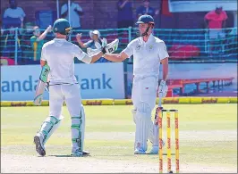  ??  ?? South Africa batsman Theunis de Bruyn (R) and captain Faf du Plessis shake hands after winning the second Test against Australia at St George’s Park in Port Elizabeth, on Monday.