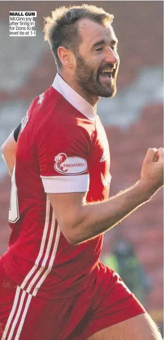  ??  ?? NIALL GUN McGinn joy after firing in for Dons to level tie at 1-1