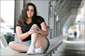  ?? (AP Photo/Steve Helber) ?? Stephanie Parris, a former inmate at Fluvanna Correction­al Center for Women, sits in Market Square on Wednesday in Roanoke, Va. Parris was finishing a two-year prison sentence for a probation violation when she heard she’d be going home three weeks early because of the COVID-19 pandemic.