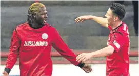  ??  ?? City goalscorer Isaac Layne, left, celebrates with Kalvin Orsi.