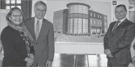  ?? JIM DAY/THE GUARDIAN ?? Charlottet­own MP Sean Casey, middle, poses with Lennox Island First Nation Chief Matilda Ramjattan and P.E.I. Senator Brian Francis in front of an artist’s conceptual drawing of the Urban Indigenous Centre. Casey announced $750,000 in funding for the facility, which will open along the waterfront in Charlottet­own in about one year.