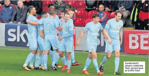  ??  ?? Sunderland’s players celebrate their second goal at Griffin Park