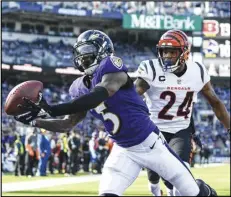  ?? Associated Press ?? Baltimore Ravens wide receiver Marquise Brown (5) catches a touchdown pass in front of Cincinnati Bengals safety Vonn Bell (24) during the second half of an NFL football game on Oct. 24 in Baltimore.