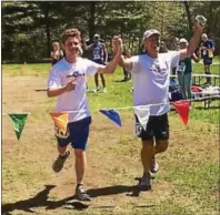  ?? SUBMITTED PHOTO ?? Fourteen-year-old Nikolas Toocheck, left, and his father, Dan, finish their 50th marathon, one in each of the 50 United States, in Springfiel­d, Vt., earlier this week.